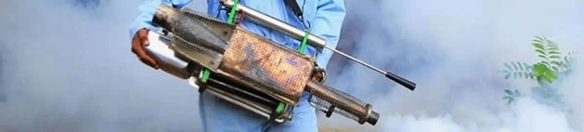 Fumigation technician using a fogger for deep pest treatment in Saint Louis, MO