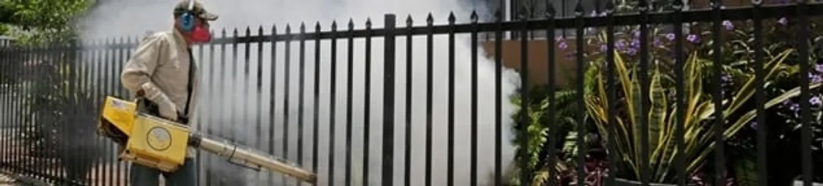 Mosquito control technician fogging a yard perimeter for mosquito reduction in Saint Louis, MO